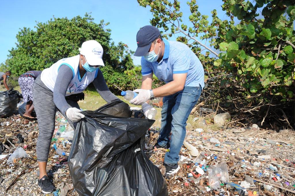 Minister and a volunteer cleaning up